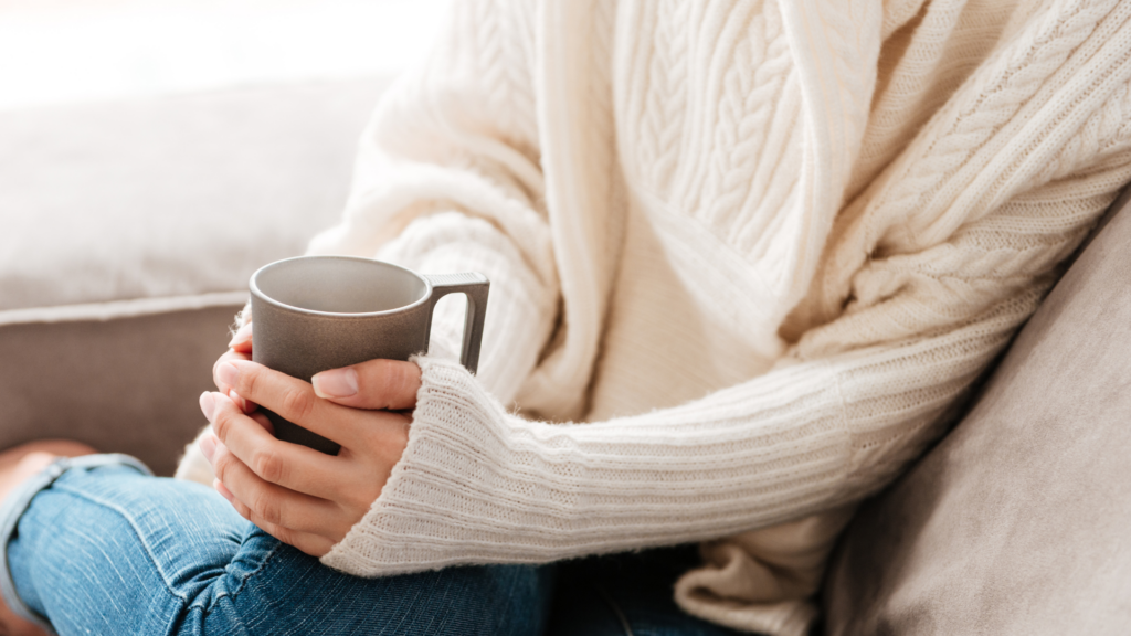 Woman enjoying a moment of gratitude with warm tea in her hands